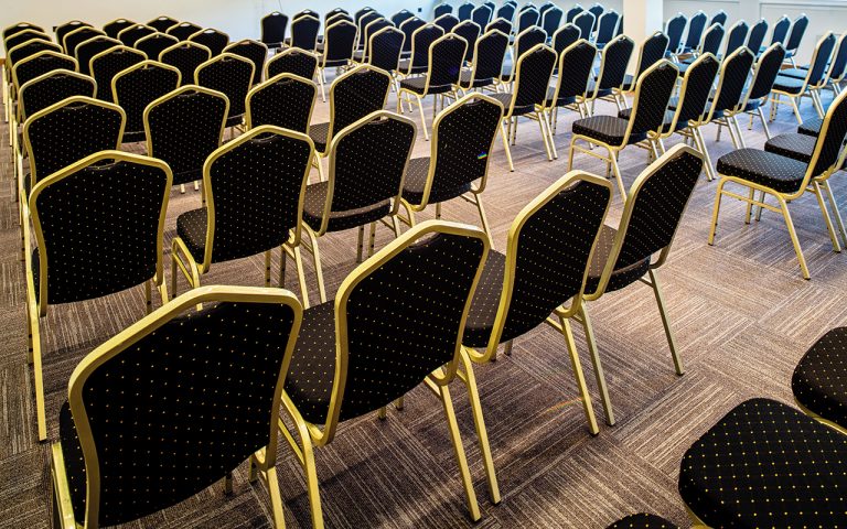 web back view chairs row with no people conference hall 768x480